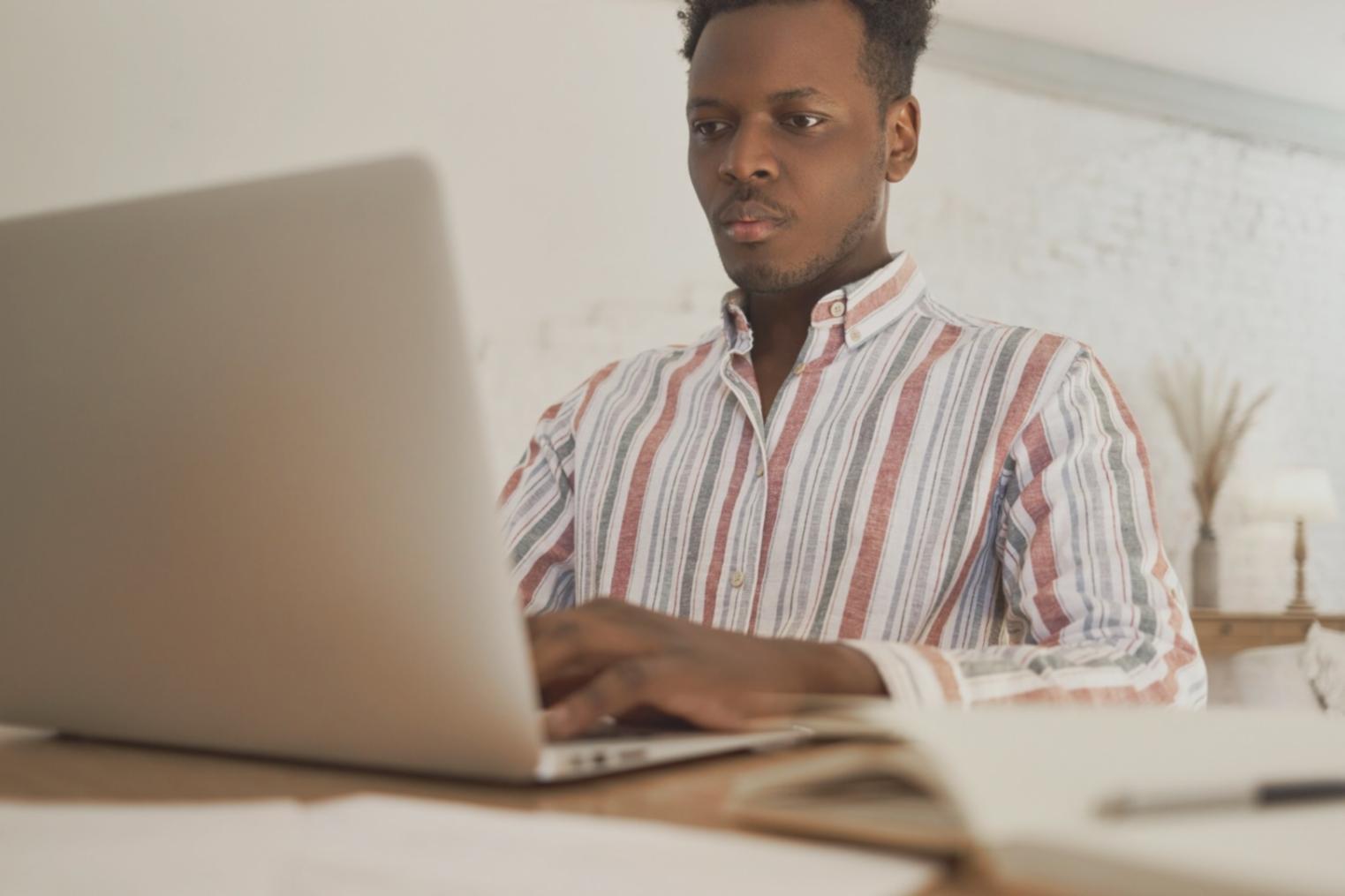 Focused individual reviewing financial documents with organized planning materials